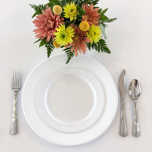 Disposable plastic plates and silverware. These stylish plates are sturdy and elegant, with delicate beading on the edges. The silverware looks real, even though it is disposable.